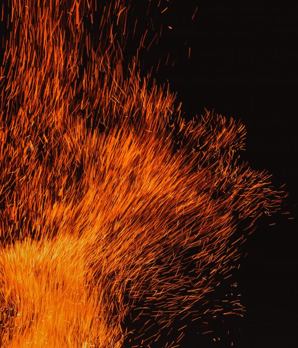 Red sparks from a burning fire.