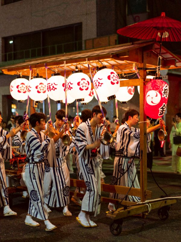 Lanterns and men wearing festival clothes at Gion festival.