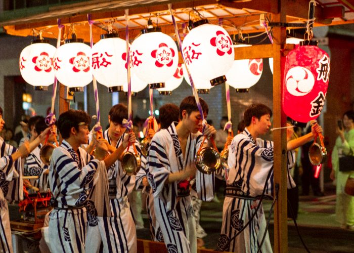 Lanterns and men wearing festival clothes at Gion festival.