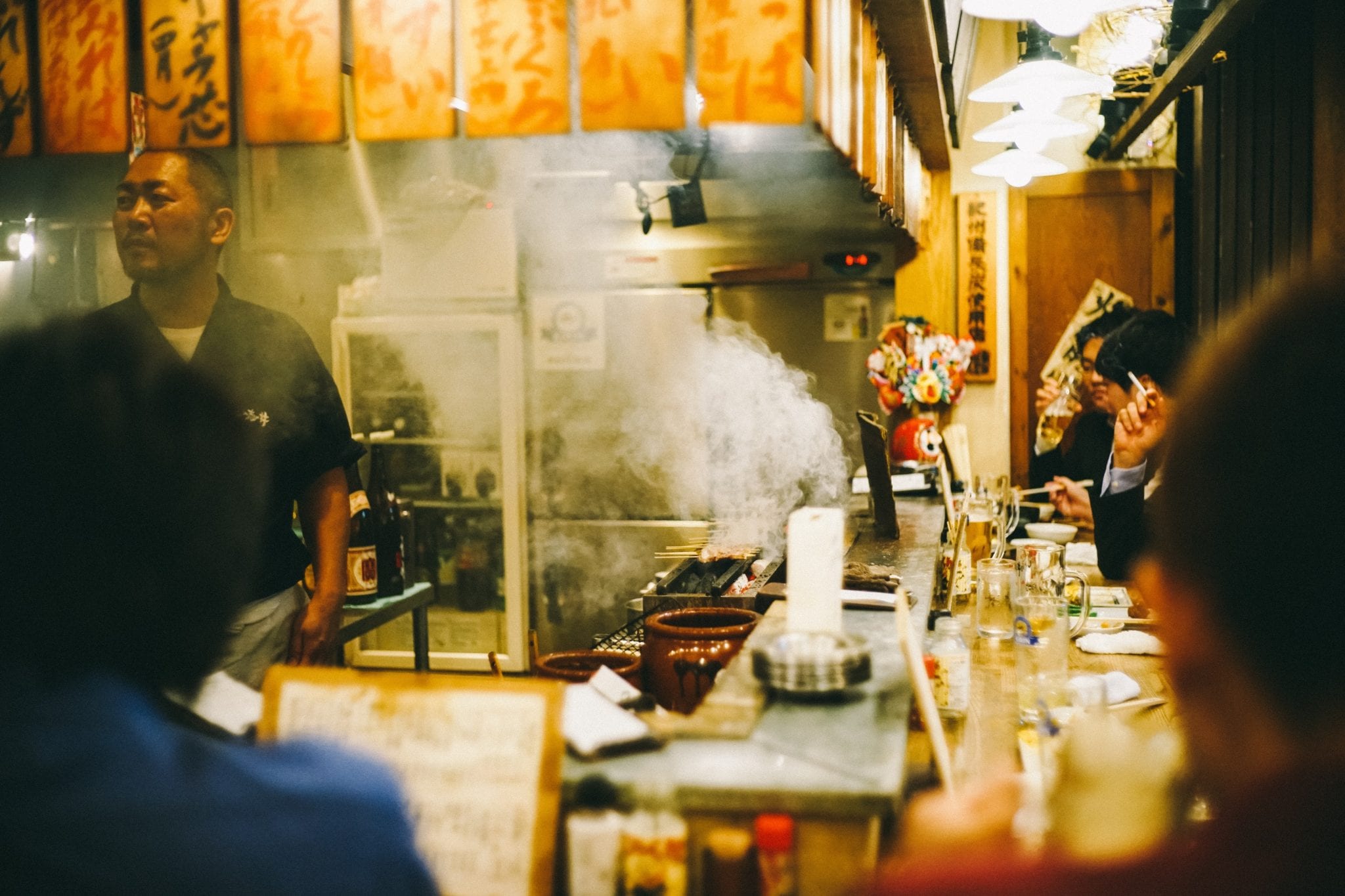 Steam coming off the grill in a Japanese izakaya